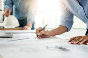 Latest Blogs & Articles 30 Close-up Of Person's engineer Hand Drawing Plan On Blue Print with architect equipment, Architects discussing at the table, team work and work flow construction concept.