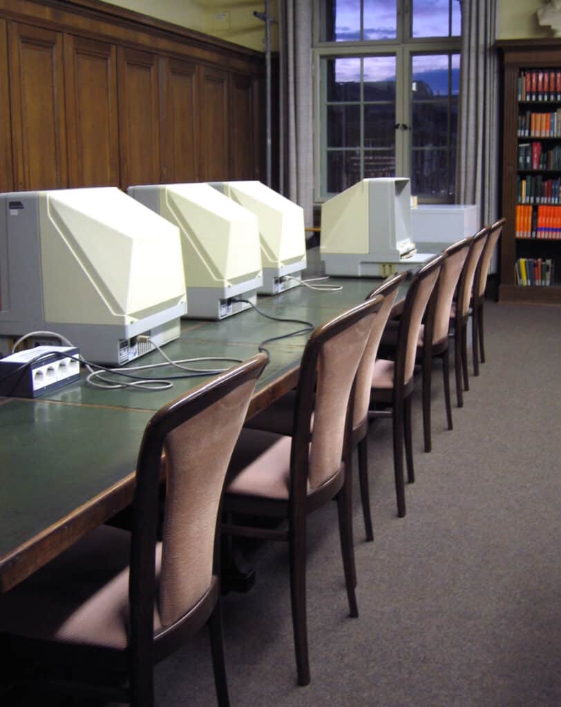 rows of chairs at a table with microfiche machines